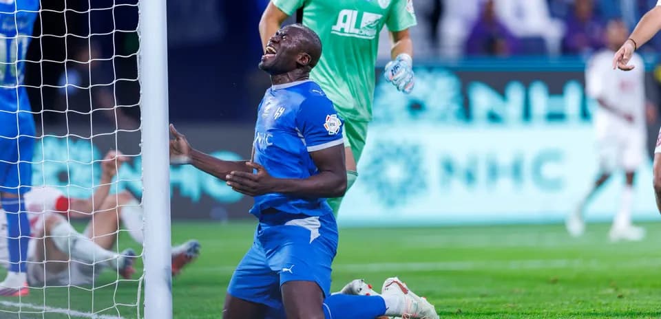 Player kneeling near goalpost after missing chance