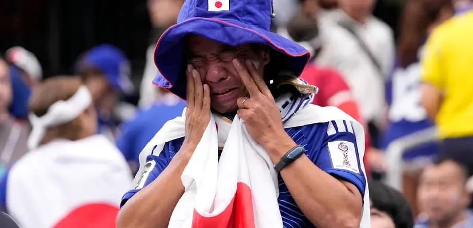 Fan wearing Japanese flag, showing emotional reaction