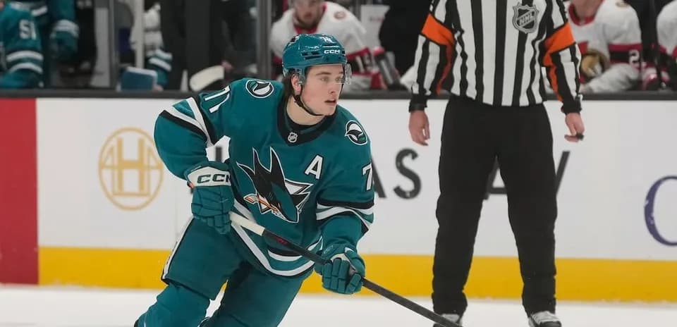 Hockey player skating during match with referee nearby