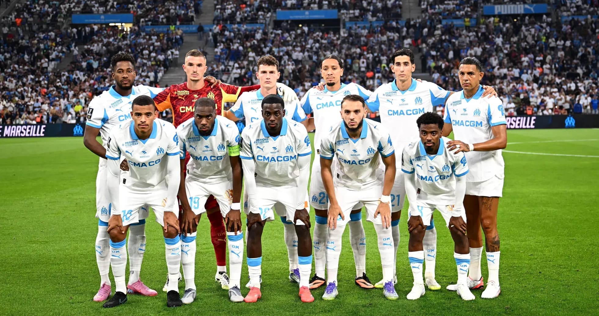 Olympique de Marseille team posing on the pitch