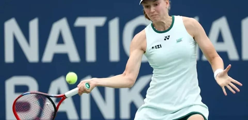 Tennis player hitting a backhand shot on court