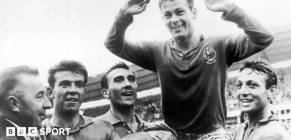 Football players celebrating victory, one lifted by teammates