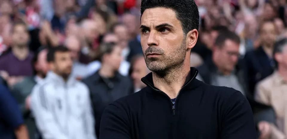 Coach observing the match with focused expression