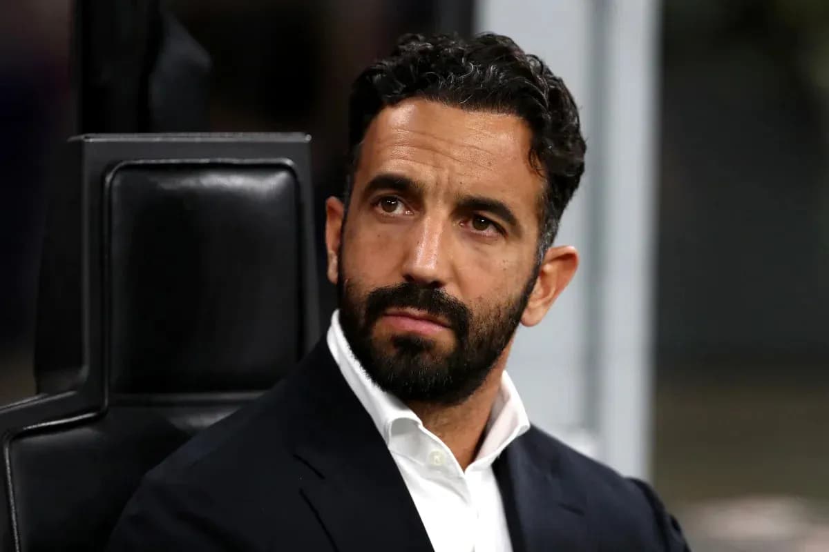 Coach seated on bench during match