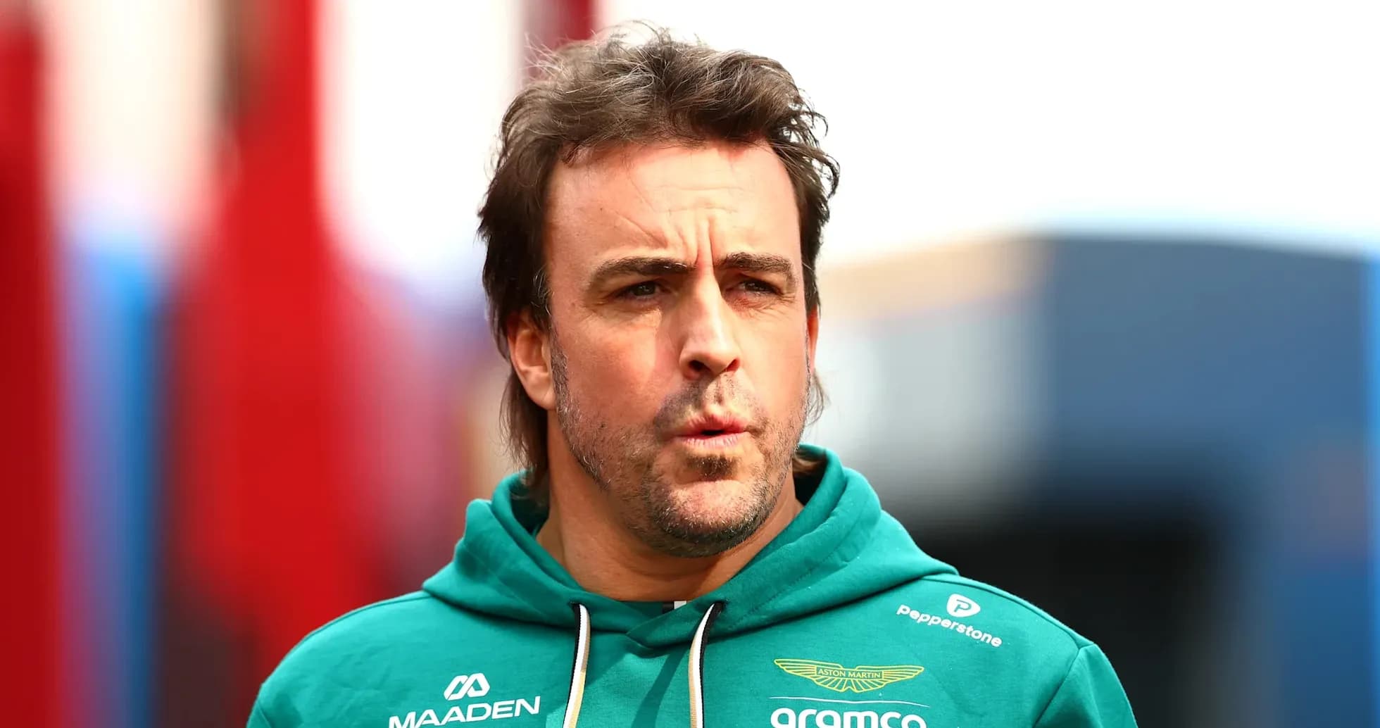 F1 driver in Aston Martin hoodie at event