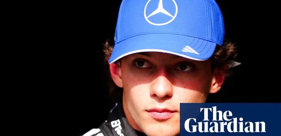 Yoshida wearing a blue cap in the paddock
