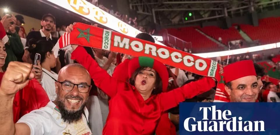 Fans celebrating with Moroccan scarves in stadium