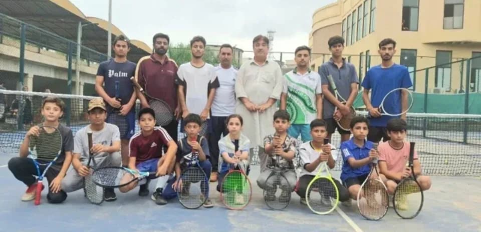 Tennis players posing together on court