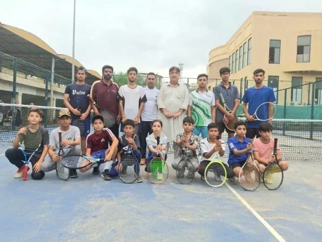 Tennis players posing together on court