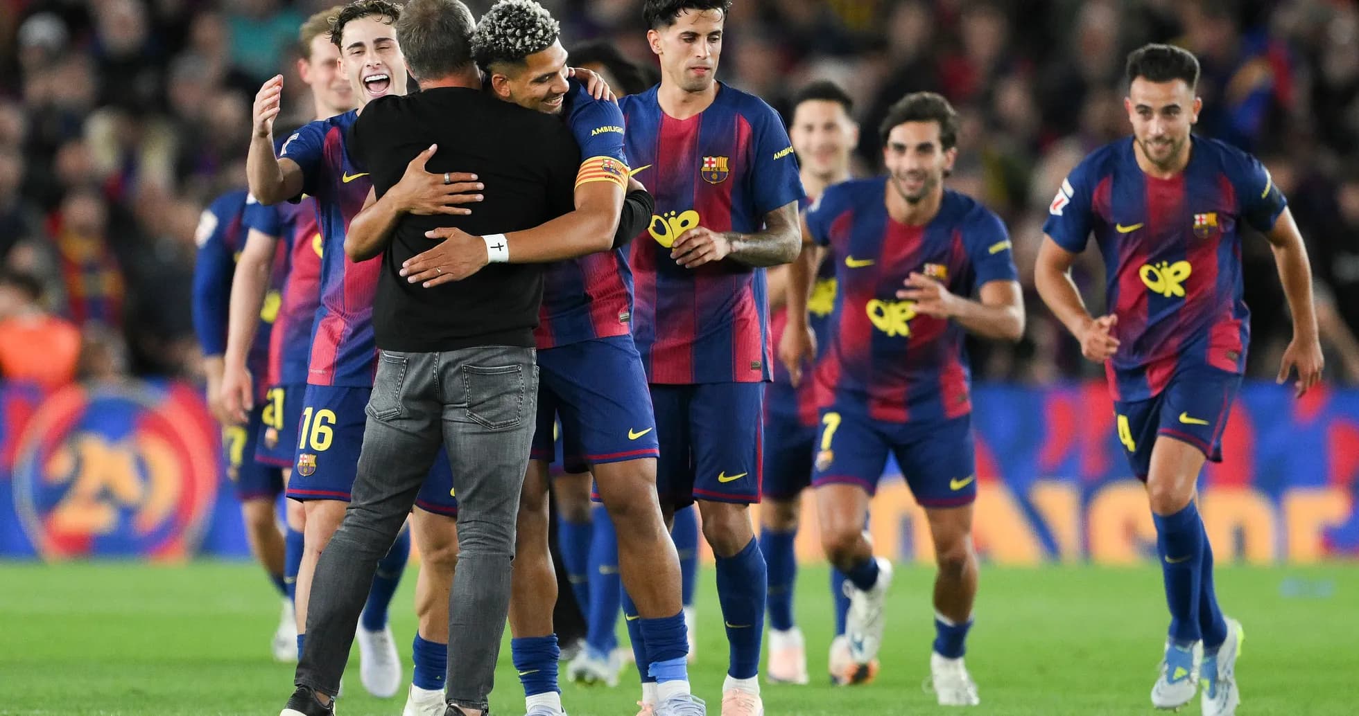 Barcelona players celebrating a victory on the pitch