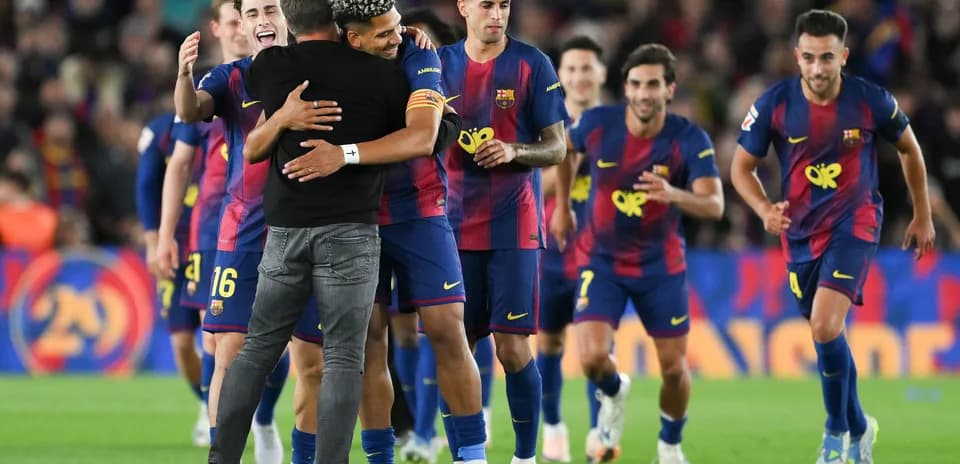 Barcelona players celebrating a victory on the pitch