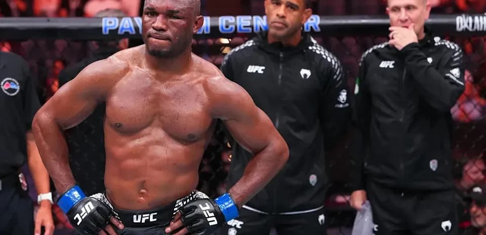 MMA fighter in octagon with coaches observing
