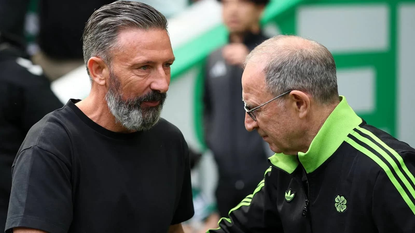 Two football coaches speaking before a match