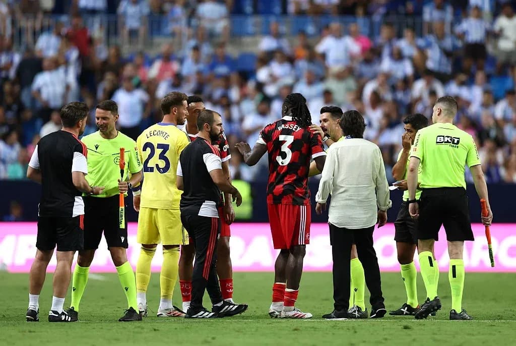 Players and officials discussing during match stoppage