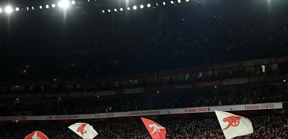 Arsenal fans waving flags at Emirates Stadium