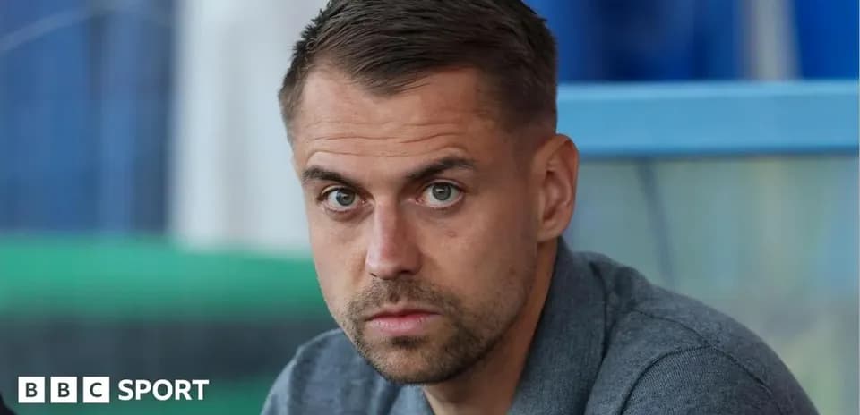 Man sitting with focused expression in stadium