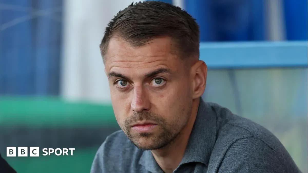 Man sitting with focused expression in stadium