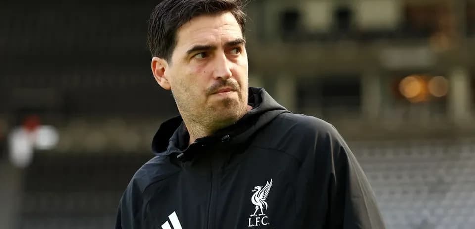 Liverpool coach on the pitch during training session