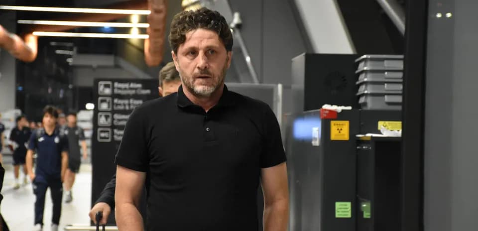 Football coach walking in airport terminal