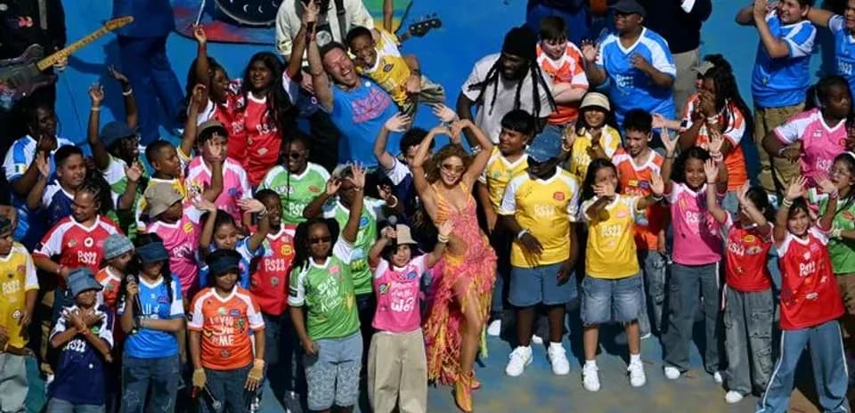 Performers and children celebrating on stage together