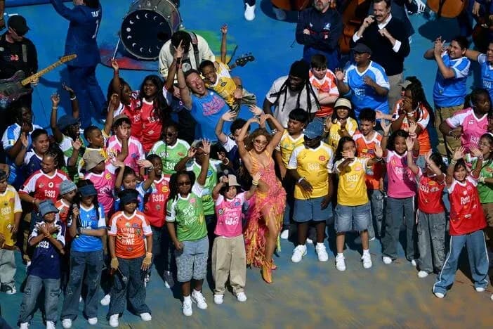 Performers and children celebrating on stage together