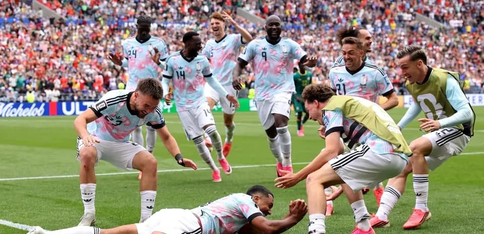 Football players celebrating a goal on the pitch