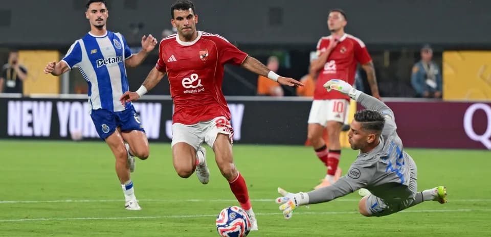 Player attempting to score against goalkeeper in match