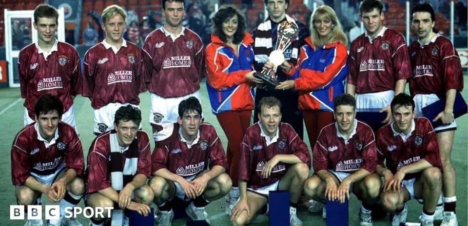 Football team posing with trophy after match