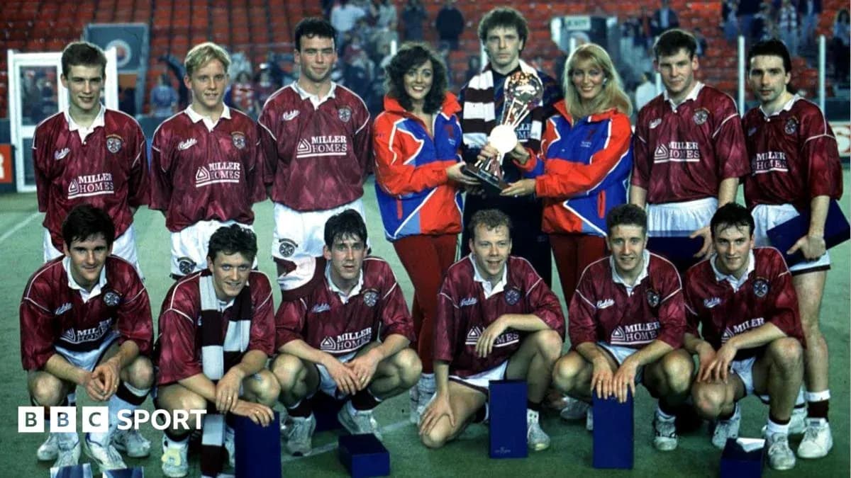 Football team posing with trophy after match