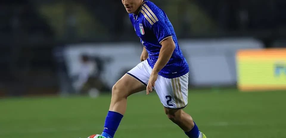Futbolchi to'pni ushlab harakatlanmoqda