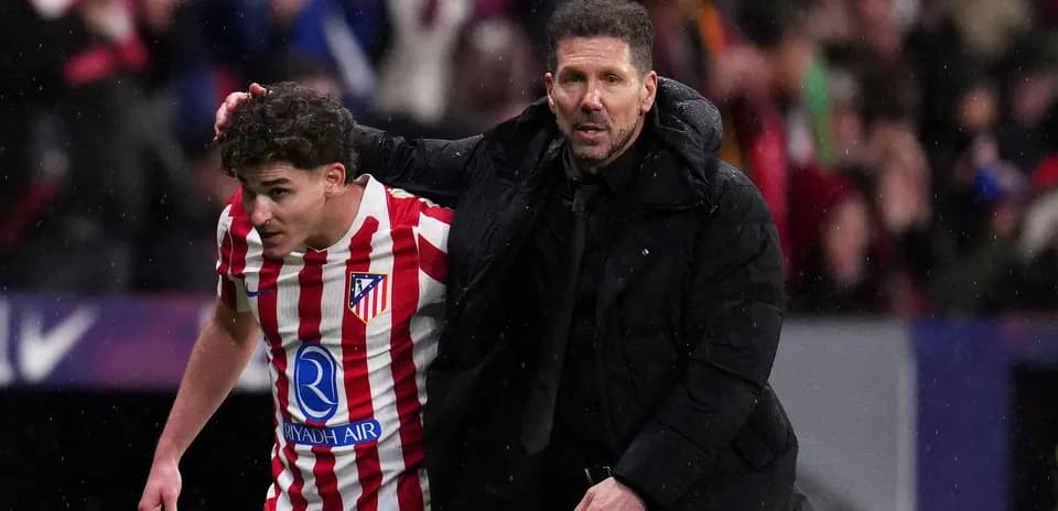 Atlético Madrid player assisted by coach during match