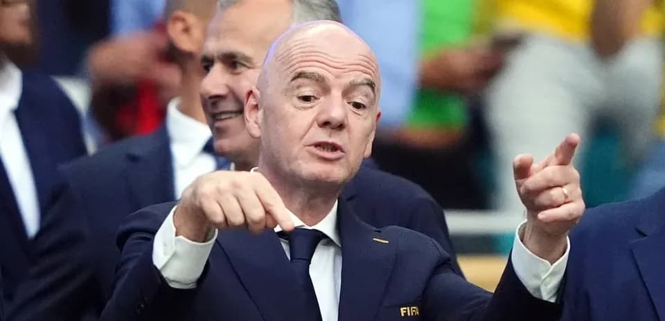 FIFA president gesturing during event with officials