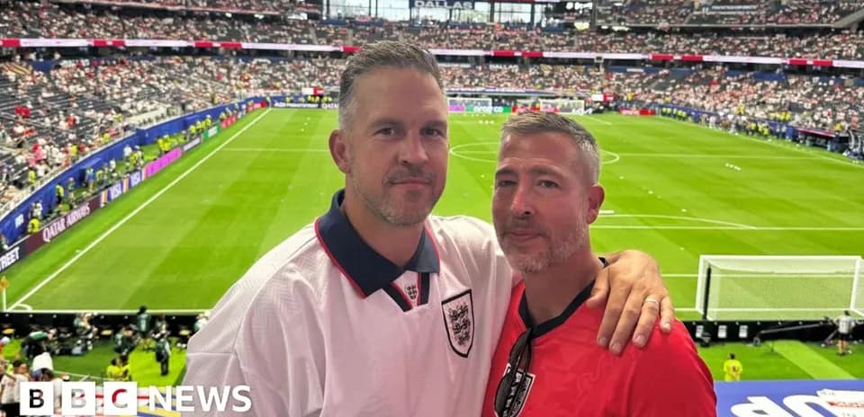 Two fans posing in stadium during match
