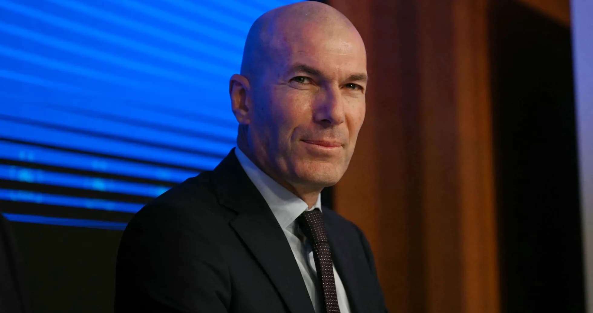 Zinedine Zidane at press conference with blue background