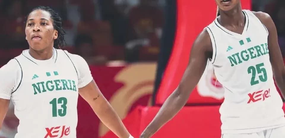 Two Nigerian players holding hands during a game