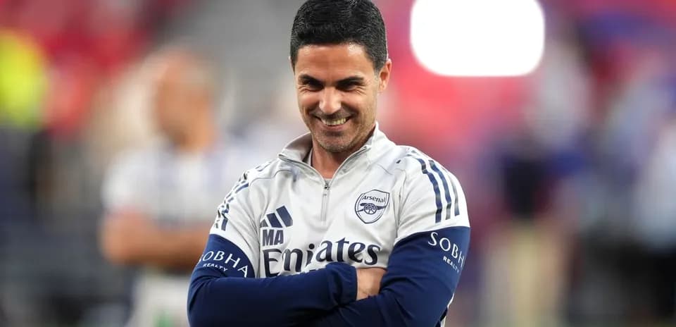 Arsenal manager smiling during pre-match warm-up