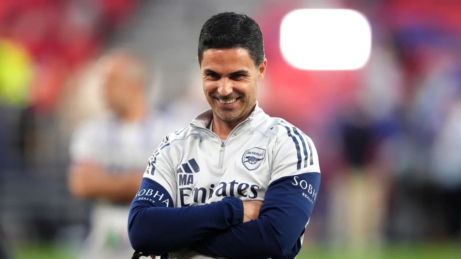 Arsenal manager smiling during pre-match warm-up