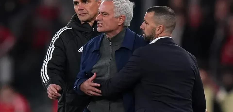 Jose Mourinho being restrained by staff during match