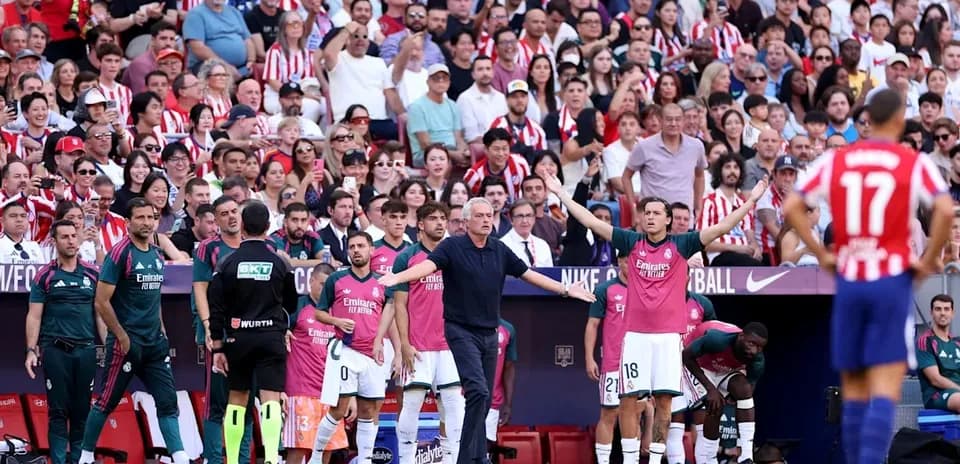Coaches and players on bench during match