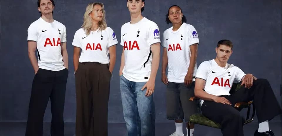 Five people wearing Tottenham Hotspur jerseys posing