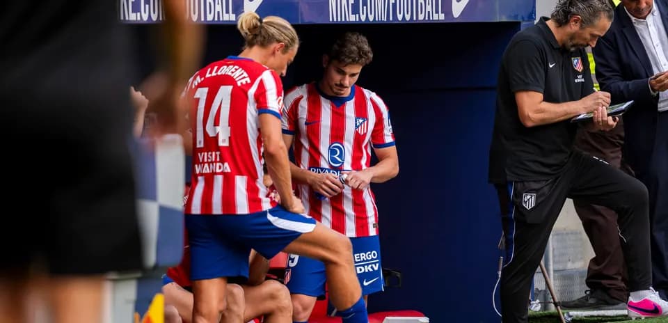 Atletico Madrid players on bench during match