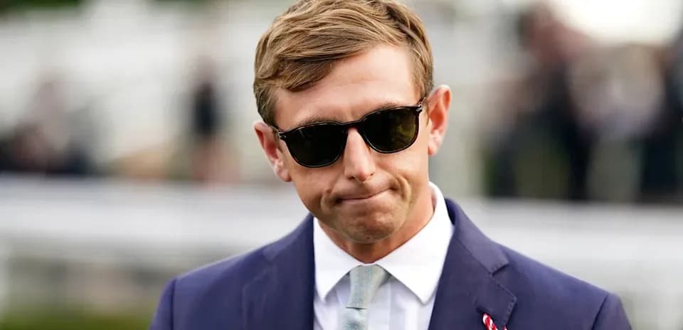 Man in sunglasses wearing a suit at event