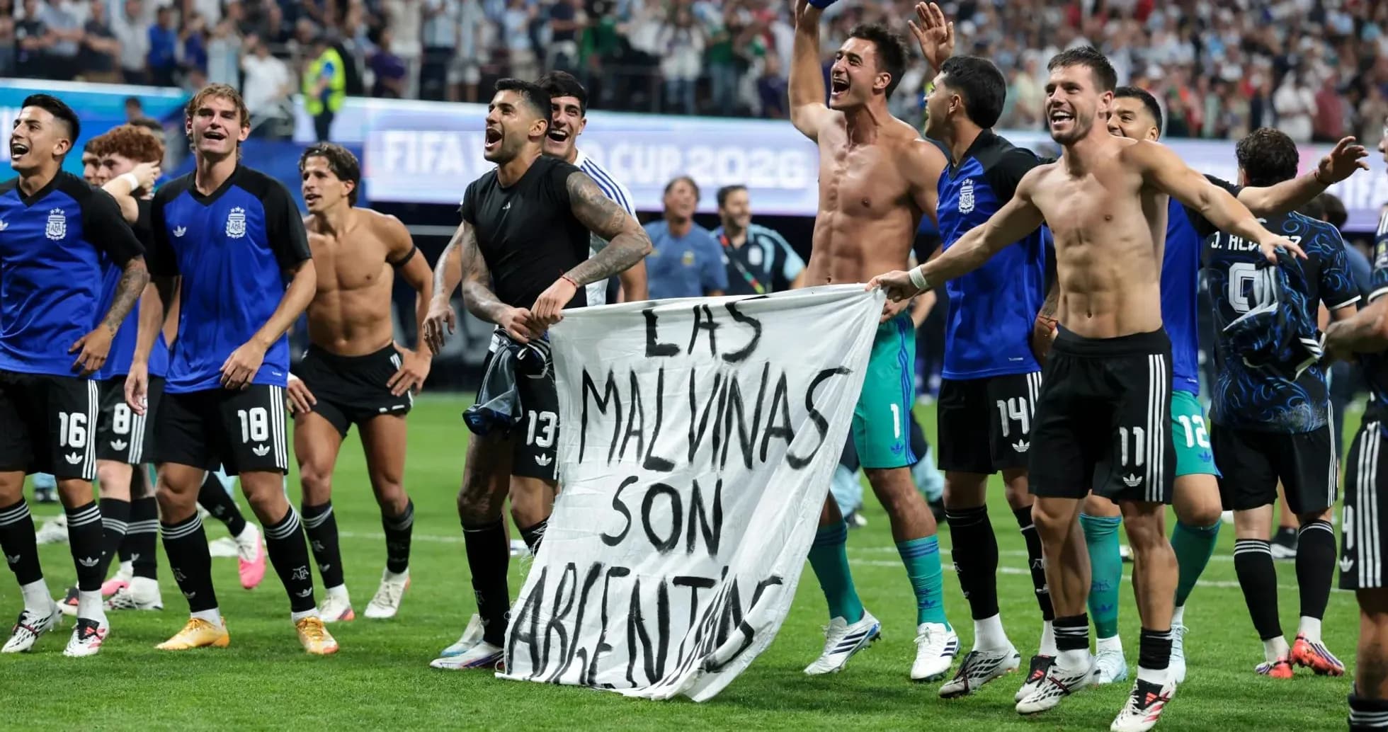 Argentinian players celebrating with a banner post-match