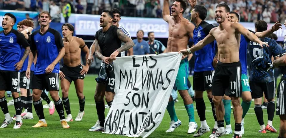 Argentinian players celebrating with a banner post-match