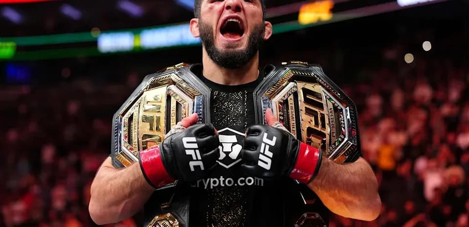 UFC champion celebrating with two championship belts