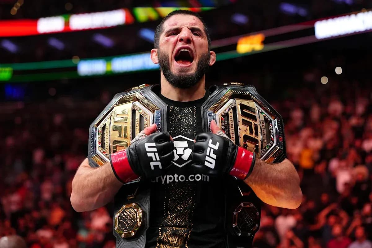 UFC champion celebrating with two championship belts