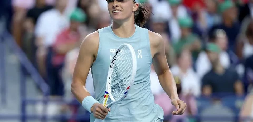 Tennis player celebrating with racket on court