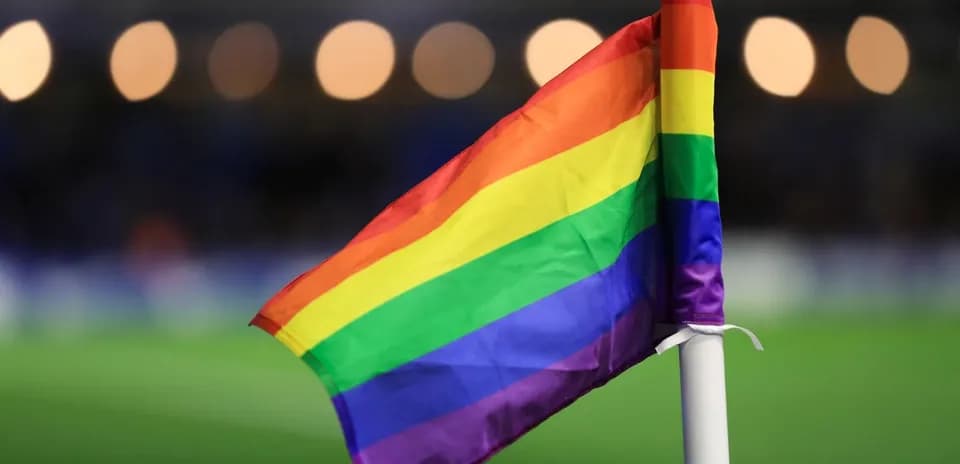 Pride flag on corner flag at football match