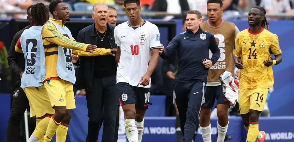 Jude Bellingham leaving the pitch with coaches and players