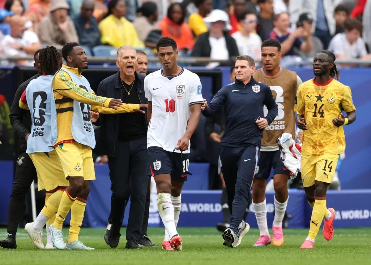 Jude Bellingham leaving the pitch with coaches and players